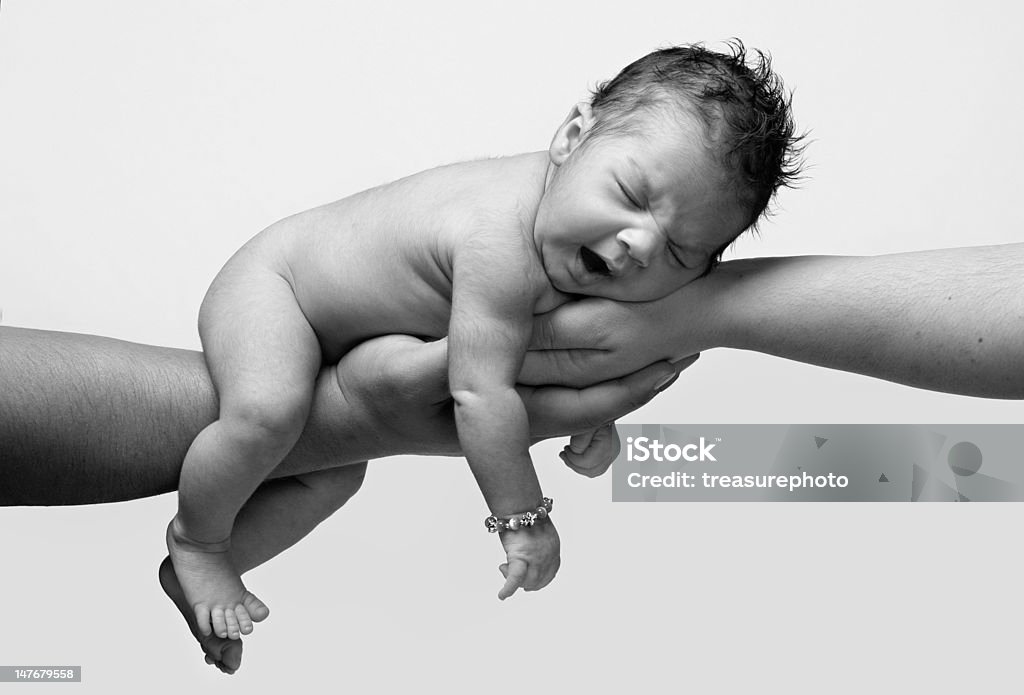 Baby Yawn newborn baby in black and white yawning and being held by both parents hands Mother Stock Photo