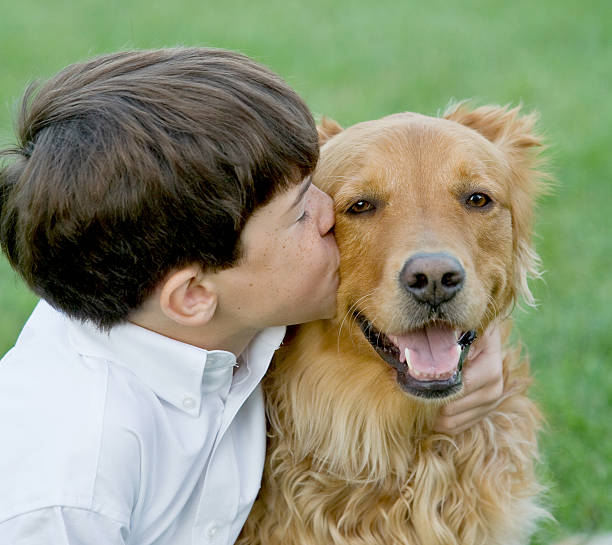istock Little Boy Kissing Dog 147679625