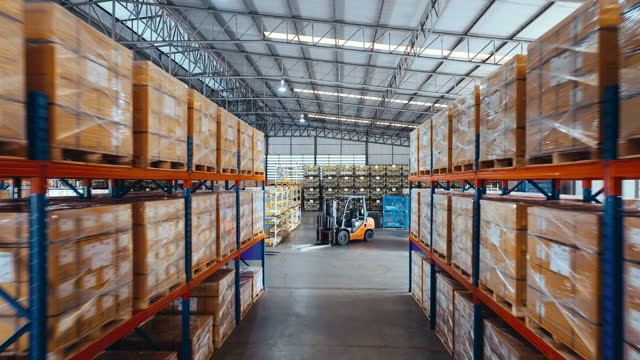 Merchandise packages stores on shelf rack in factory warehouse, drone aerial view fly forward. Logistic industry business, industrial job career, factory work environment concept