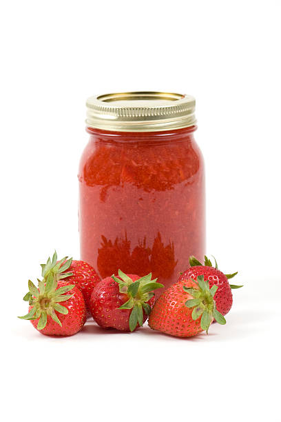 istock A jar of strawberry jam with strawberries besides it 147679750