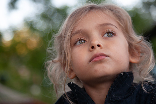 Low angle view of a child looking away in the park