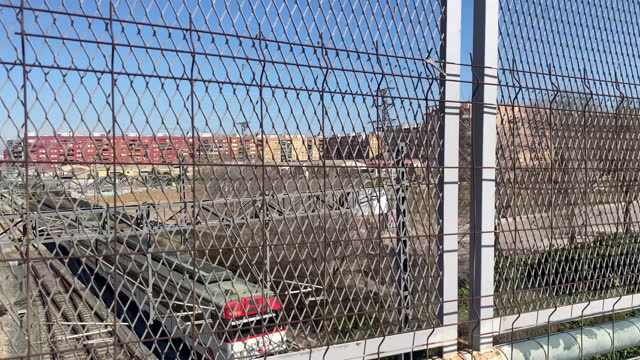 Railroad tracks behind chainlink fence