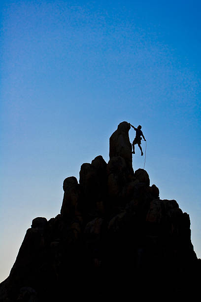istock Male rock climber reaching the summit. 147680048