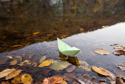 Colorful paper boats, beautiful autumn colors of  lake reflection in Boraboy Lake and like wallpaper