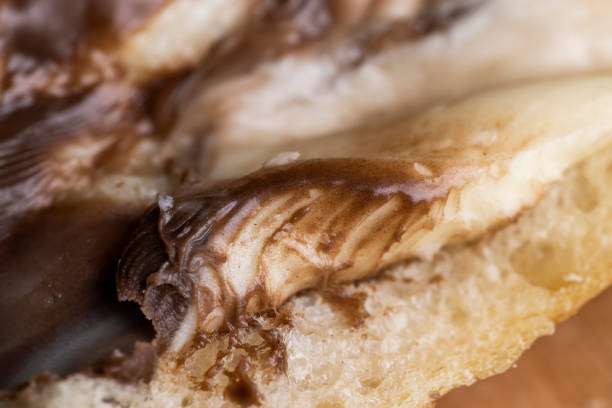 slices of bread with chocolate butter on the table, cooking a simple homemade sweet dessert using chocolate butter with white bread