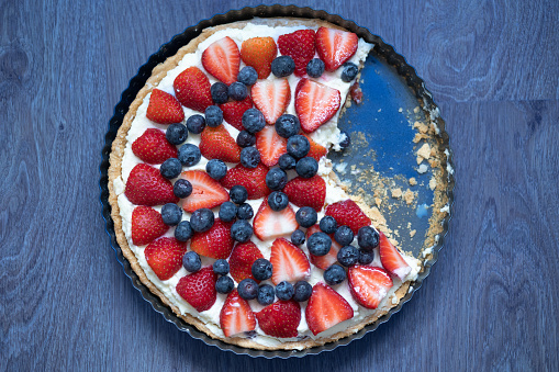 Strawberry Tart with Blueberries. Blue Background.