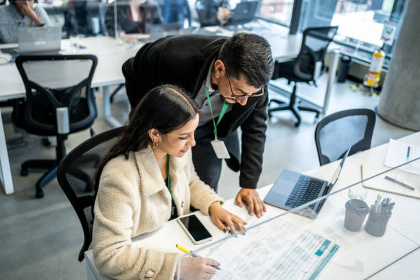 leader businessman helping young woman in the office - coach imagens e fotografias de stock