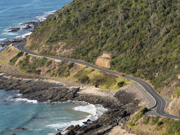 istock Winding road with red car 1476804518