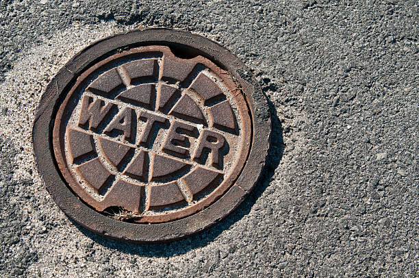 istock Sewage drain marked water on the cement road 147680645