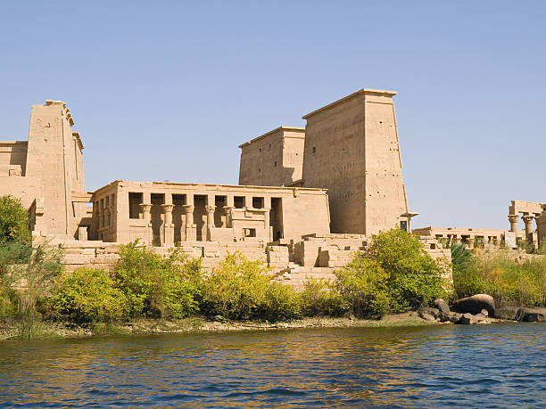 Isis Temple View of Philae Island from a boat. temple of philae stock pictures, royalty-free photos & images