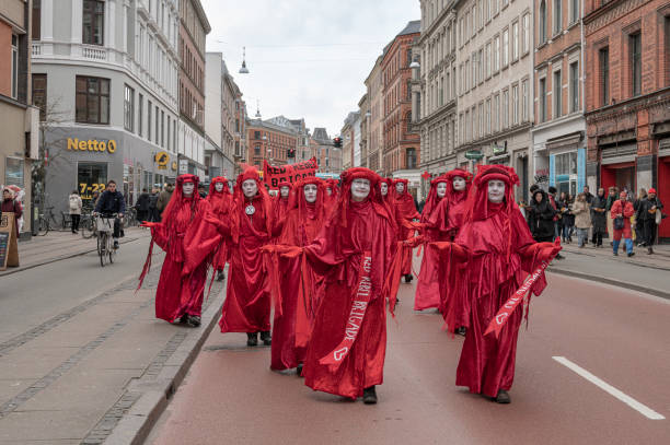 Extinction Rebellion protest march in Copenhagen Denmark Copenhagen, Denmark, 25 th Mar 2023, Extinction Rebellion protesters and the Red rebel brigade march through the streets of Copenhagen extinction rebellion stock pictures, royalty-free photos & images