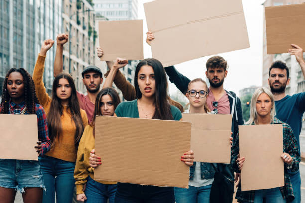 istock Young protestors strike with blank banners - freedom movement gender equality social issues green global warming vaccination green pass sustainability work conditions war 1476810695