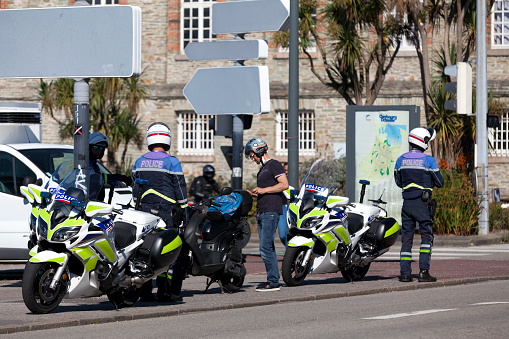 Cherbourg-en-Cotentin, France - August 06 2020: National police bikers checking a scooter driver.