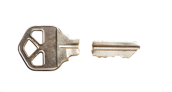 Close-up showing house keys in the lock of the front door to a house.