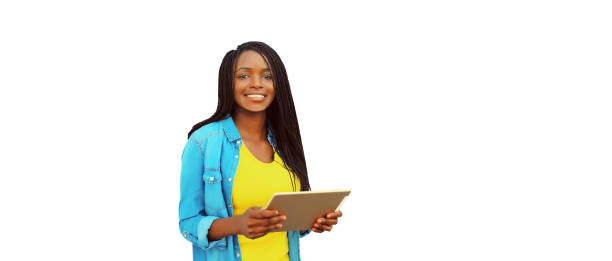 Portrait of happy smiling young african woman with tablet pc on white background stock photo