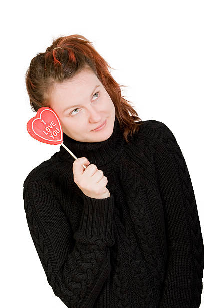 Girl with red heart shaped candy stock photo