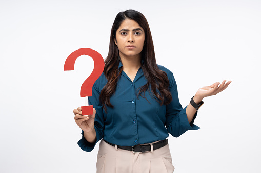 Portrait of Businesswoman holding question mark on white background