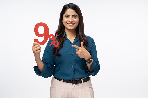 Portrait of Businesswoman holding financial figure on white background