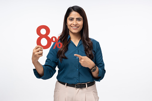 Portrait of Businesswoman holding financial figure on white background