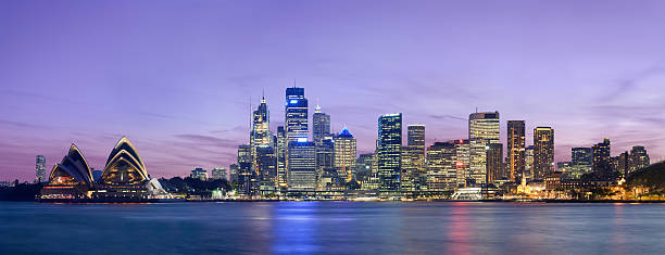 Panorama of the Sydney skyline at dusk with purple sky stock photo