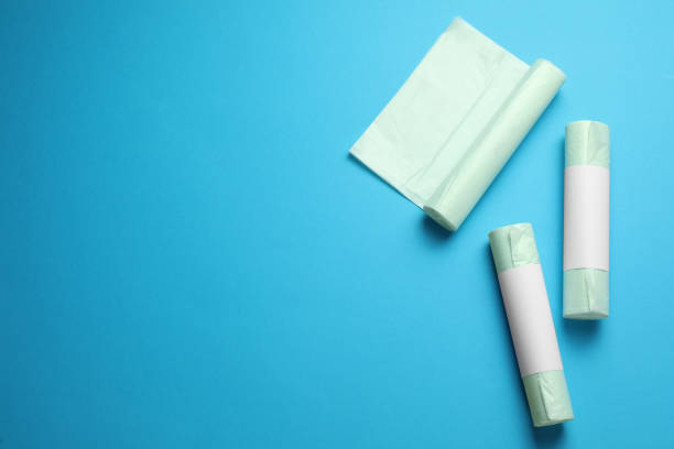 istock Rolls of different garbage bags on light blue background, flat lay. Space for text 1476822172