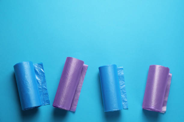 istock Rolls of different garbage bags on light blue background, flat lay. Space for text 1476822193