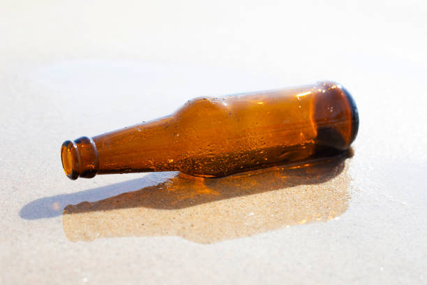 istock Glass bottle on the beach 1476824392