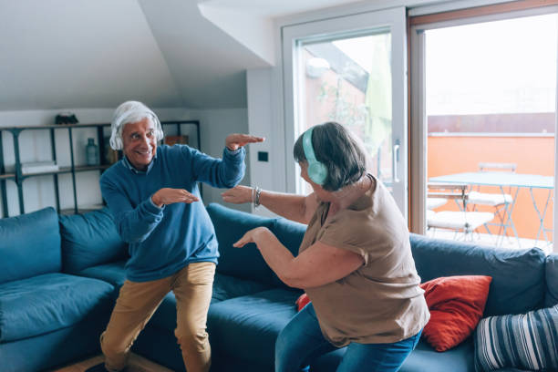 istock senior couple having fun playing and dancing at home 1476830277