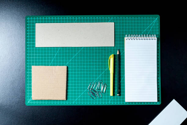 istock Craft table with clipboard, note sticker pen, pencil, paper scissors and cardboard. 1476830321