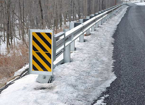 Guard rail with warning sign stock photo