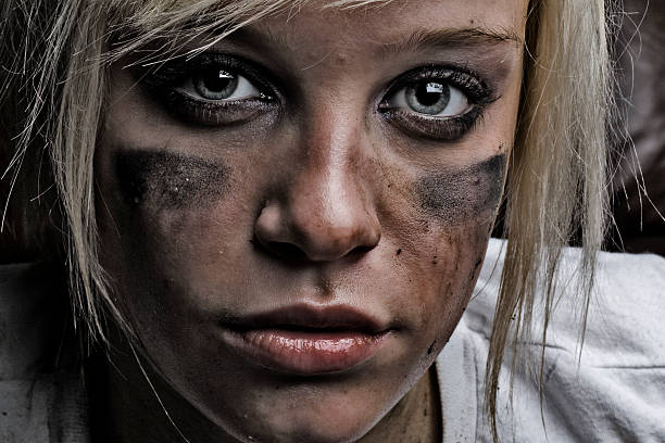 serious girl with gun on black background with copyspace