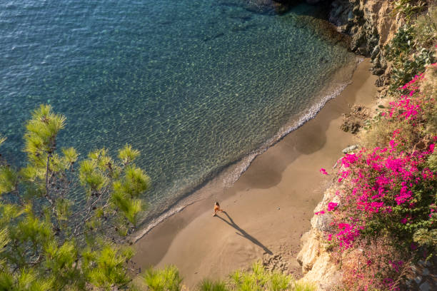 Woman on a stunning Beach in Agia Pelagia, Crete stock photo
