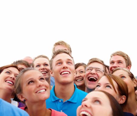 Close-up of happy young men and women looking up