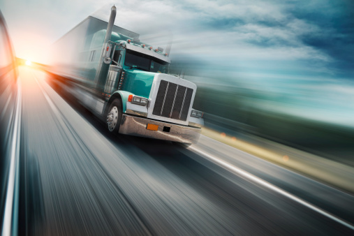 American truck speeding on freeway, blurred motion.