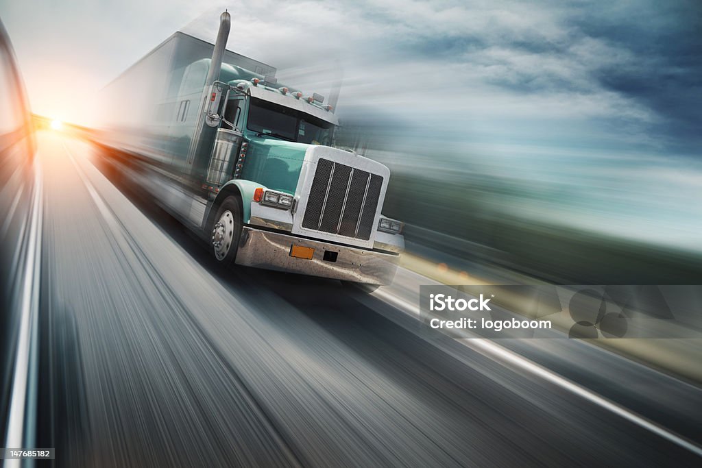 Truck on freeway American truck speeding on freeway, blurred motion. Semi-Truck Stock Photo