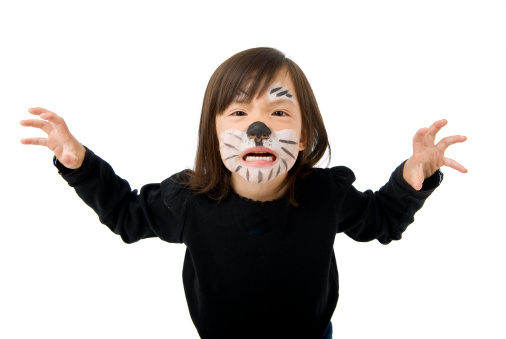 A young asian girl dressed up as a tiger