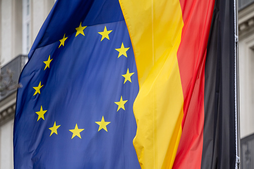 Picture of the flag of Germany and the flag of the EU together in front of a building of Aachen. Germany is one of the main members of the European union since it joined the community in 1957