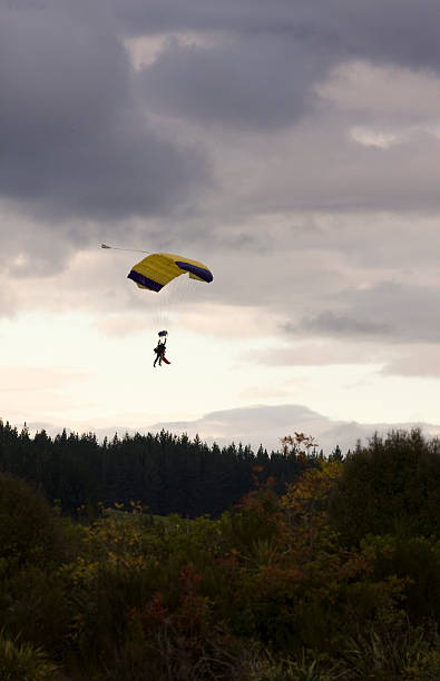 istock Tandem Paragliders Decending onto Ground 147686757