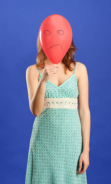 istock girl holding red angry balloon 147687610