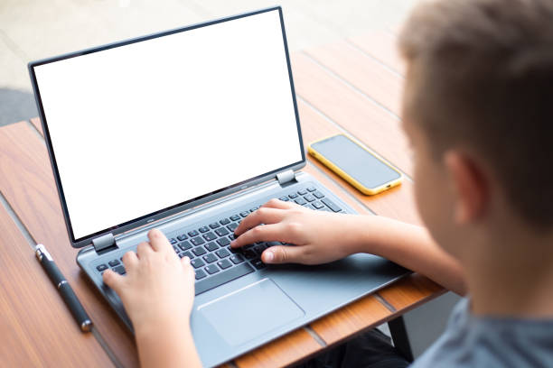 istock Teenage boy with laptop outside. Blank screen concept. 1476877332