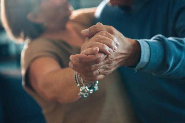 istock senior couple dancing hand in hand - elderly taking tango course 1476880885