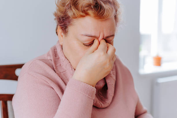 istock Stressed Senior Woman at Home Feeling Sad and Achy While Reading with Glasses 1476887039