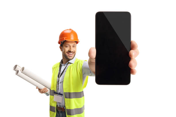 istock Engineer holding blueprints and showing a smartphone 1476894764