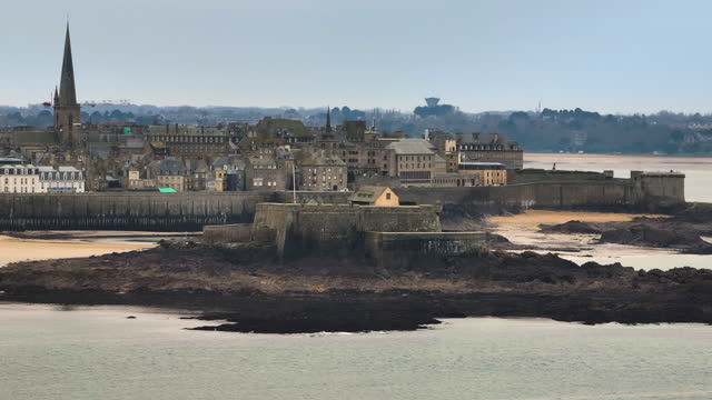 French landmark on the Atlantic coast in Brittany. Medieval ancient fortress washed by the ocean, a popular attraction for all tourists. Drone shot of the city of Saint Malo