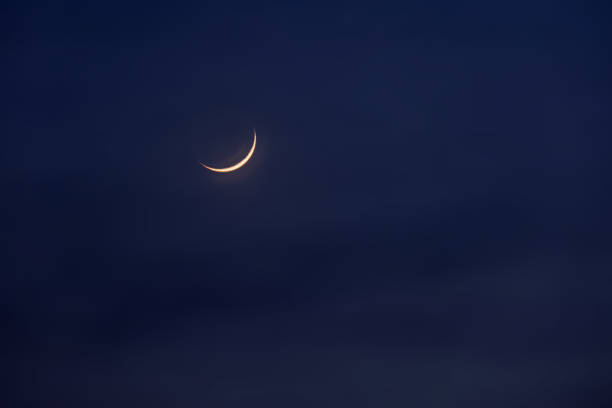 istock New moon in the initial phase on a dark night sky 1476901143
