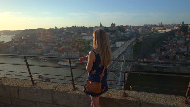 Video of a woman looking at sunset in Porto.