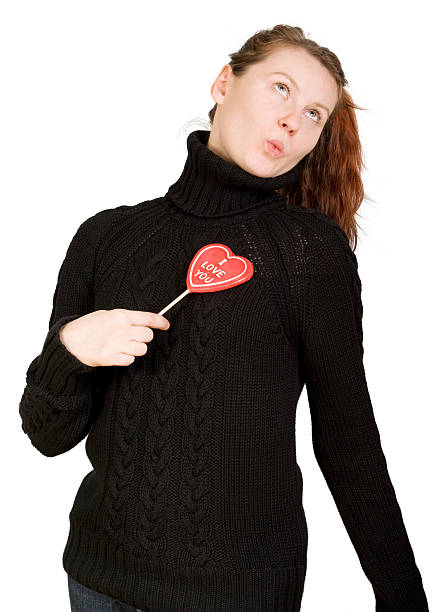 Girl with red heart shaped candy stock photo