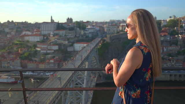 Video of a woman looking at sunset in Porto.