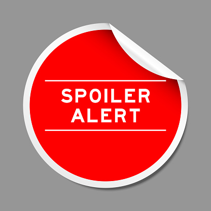 Red color peel sticker label with word spoiler alert on gray background