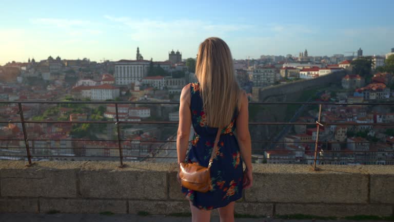 Video of a woman walking at sunset in Porto.